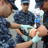Master-at-Arms 1st Class Andy Whittington, left, and Master-at-Arms 2nd  Class Shane Harrison speak to an 8th grade class at the Department of  Defense Dependent School Sigonella.