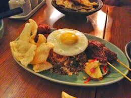 It consists of rice cooked in coconut milk that is traditionally served with anchovies, cucumbers with its popularity came different variations of the dish, and nowadays chicken, fried fish, fried eggs, or even curry are served on the side of nasi lemak. Nasi Goreng History All About Indonesia S Famous Fried Rice Foodicles