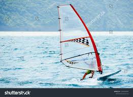 Windsurfing On Lake Garda Unidentifiable Windsurfer Surfing The Wind On Waves Recreational Water Sports Selective Focus Ad Lake Garda Windsurfing Lake