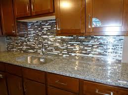 A modern kitchen utilizes a metallic backsplash that creates depth and dimension using different sheens and surfaces. Easy Backsplash Treatments