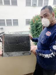 Man installing an air conditioning unit in a window by yourbestdigs is licensed under cc by 2.0. Wildfires And Cleaning Your Ac S Coils Kilowatt