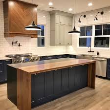 One could be used for prepping meals, while the other this particular kitchen is balanced with wood open shelving and white cabinetry and subway tiles. Wood And Granite Waterfall Top Island Wood Top Island Kitchen Kitchen Room Design Black Kitchen Island