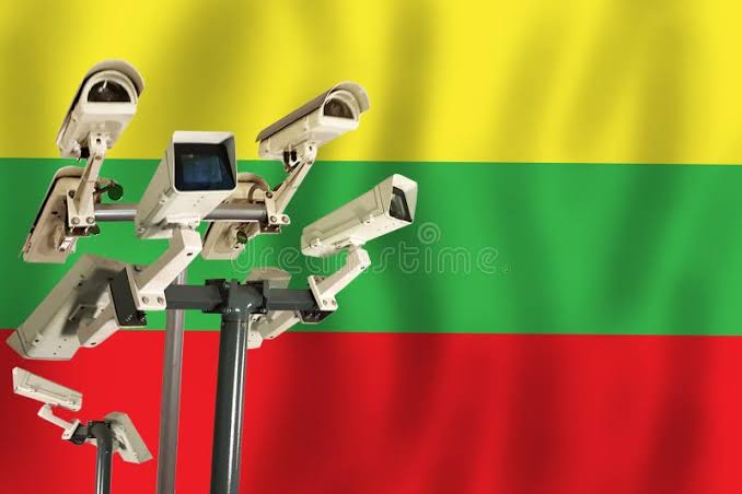 Lithuanian flag displayed alongside modern military surveillance equipment.