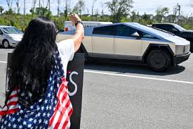 Tesla Takedown' campaign erupts for its biggest protest weekend yet : NPR