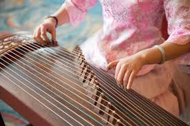 The sound of ancient china itself. High Angle Close Up Of Woman Playing Traditional Japanese Koto String Instrument Stockphoto