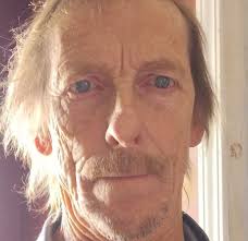 The King of Cool, Steve McQueen racing in the 1964 International Six Day  Trial with team USA. He wears a 1960s white label Barbour Motorcycle Jacket.