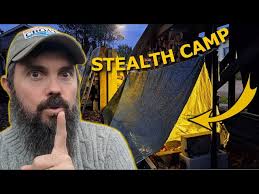 stealth camp with leaf bedding and survival tent