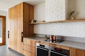 Simple and traditional, the white backsplash matches with the overall kitchen's white hue. 20 Dynamic Kitchens With Exposed Brick Backsplashes Dwell