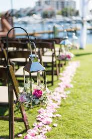 It's common to decorate a wedding aisle with fresh flower arrangements, potted plants or candles and tea lights. A Tiffany Blue Inspired Wedding In Florida Wedding Aisle Decorations Hanging Lanterns Wedding Wedding Aisle Outdoor