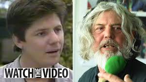 Neighbours legend looks unrecognisable with long silver hair and bushy  beard as he watches The Ashes