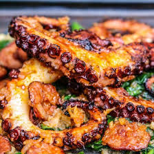 Red Wine Braised Octopus Finished On The Grill And Topped With A Smoky Chorizo Paprika And Lemon Sauce Braised Octopus Recipe Octopus Recipes Grilled Octopus