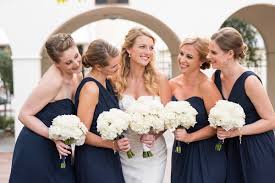 Couple sporting boho and classic details. Elegant Ivory And Navy Vintage Florida Wedding Aisle Society