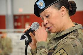 Command Sgt. Maj. Lisa Haney wipes away tears during