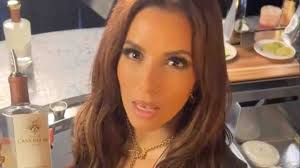 Eva Longoria, 48, bartends at restaurant in sky-high heels and low-cut vest  as admits she needs to 'watch her mouth'