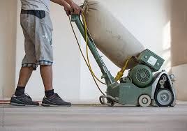 Carpenter Sanding A Wooden Floor With Sander Machine By T Rex Flower For Stocksy United Wooden Flooring Flooring Sanding