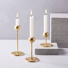 These brass candleholders balance bulbed ends on slim stems for a streamlined, sculptural effect. Modern Brass Candle Holders