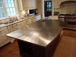 This simple island has black metal legs and a manufactured wood top, and its open shelves are ideal for storing pots, pans, small appliances, cookbooks, and more. Stainless Steel Countertop On A Kitchen Island Simple Kitchen Remodel Stainless Steel Countertops Cost Cheap Kitchen Remodel