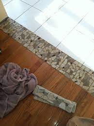 Choosing the correct type of transition will depend on several factors, including elevation, flooring material and its location. Stone Threshold Between Tile And Wood Transition Flooring Wood Tile Floors Tile To Wood Transition