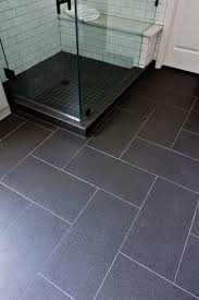 Wood effect grey tiles are spot on trend offering the natural wood effect in plank size tiles, perfect for use on your bathroom wall and floor. Before And After A Dated Builder Bathroom Becomes An Eye Catching Modern Retreat Designed Black Floor Tiles Black Tile Bathrooms Tile Bathroom
