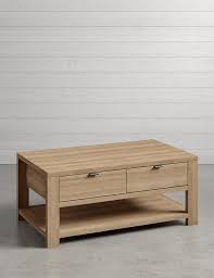 A coffee or cocktail table is a style of long, low table which is designed to be placed in front of a couch to support beverages, books or magazines. Arlo Storage Coffee Table M S