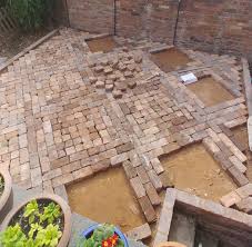 Starting at one corner, place each brick next to each other on the sand. How To Lay A Patio From Reclaimed Bricks Alice De Araujo