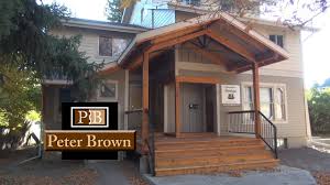 Burgundy and pink accents found in the japanese maple , rose, loropetalum, and caladium brighten garden beds and complement the home's exterior. Covered Front Porch Design In Bozeman Mt Bozeman Remodeling Peter Brown Innovative Design