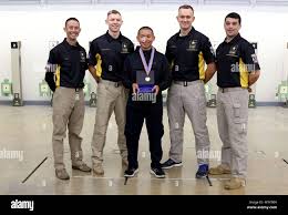 International Rifle Team Soldiers pose with Matthew Sanchez of Orlando,  Fla. who is a junior member of the Central Florida Rifle and Pistol Club.  Sanchez is the winner of the first smallbore
