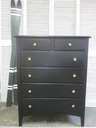 Distinctive textured drawer fronts with gold handles are bordered by mahogany solids and veneers. Tall Black Dresser With Gold Flower Knobs Entri Ways