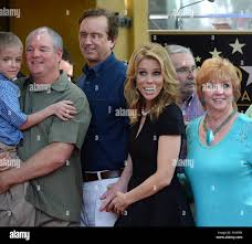 Surrounded by family members including her mother Rosemary Harbolt, actress  Cheryl Hines holds the hand of her beau Robert Kennedy Jr. pose during an  unveiling ceremony honoring Hines with the 2,516th star