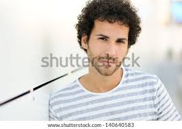 You can have so much fun with your bangs! Portrait Of Handsome Man With Curly Hairstyle Smiling In Urban Background Stock Images Page Everypixel