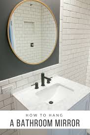 Video Tutorial How To Hang A Bathroom Mirror The Diy Playbook Round Mirror Bathroom Bathroom Mirror Tile Bathroom