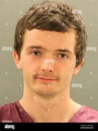 This photo provided by the New Castle County Police shows Joshua August.  Police in Delaware charged August who they said assaulted an elderly  Catholic priest, dousing him in wine and hitting him