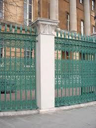Black metal gate with forged ornaments on a white background. Paint Colors For Iron Gates And Fences Gardenista