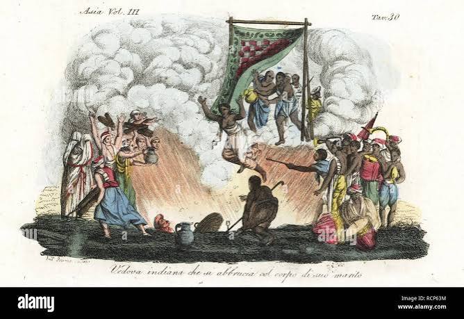 Indian sati or suttee ritual. A widow throws herself onto her late husband's funeral pyre. Handcoloured copperplate engraved and drawn by Andrea Bernieri from Giulio Ferrario's Ancient and Modern Costumes of all