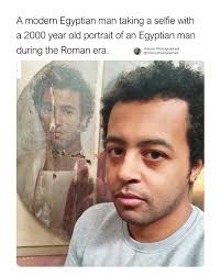 An Egyptian man was photographed taking a selfie with a 2,000-year-old  Roman-era portrait of an Egyptian man who bears a striking resemblance to  him.