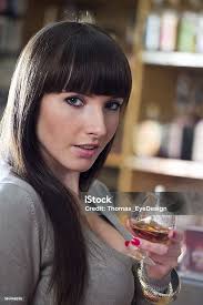Young Woman Holding Glass Of Brandy Stock Photo