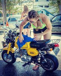 image may contain one or more people people sitting motorcycle and outdoor biker girl outfits cafe racer girl mini bike