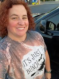 The woman was wearing a Hocus Pocus t-shirt and sandals.