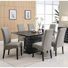 A charming pendant light stands out in this dining room featuring a smooth wooden dining table surrounded by white high back chairs and a cushioned bench over the gray shaggy rug. Stanton Dining Room Set With Gray Chairs Coaster Furniture Furniturepick