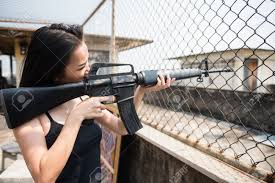 The rifle received high marks for its light weight, its accuracy, and the volume of fire. Asian Woman Aim M16 Rifle Gun To Victim From Iron Fence Of Roof Stock Photo Picture And Royalty Free Image Image 107471626