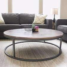 First they're great if you have kids or pets or find yourself constantly bumping into things because they're there are tons of variations in wood from the texture to the color, and they are often mixed with other materials, so you'll have no problem finding. Drum Barrel Green Metal Armchair The Spotted Door Round Coffee Table Living Room Coffee Table Round Wood Coffee Table