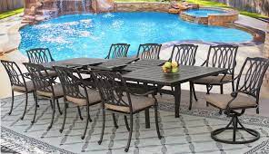 Crafted of aluminum in a blackened bronze finish, this classic design strikes a round silhouette with latticework paneling and four curvy legs. San Marcos Cast Aluminum Outdoor Patio 11pc Set 44x130 Rect Extendable Dining Table Series 4000 With Sunbrella Sesame Linen Cushion Zenpatio