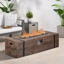 Modern in every sense of the word, this elegant tabletop fireplace sports a sleek black metal base, a removable cylindrical glass body, and reusable fiberglass for use with ethanol fuel, decorative. Indoor Fire Pit Coffee Table Wayfair
