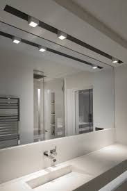 This bathroom with white and black tiles, with a unique ceiling design giving it a contemporary look. Apartment Paris Ii Kreon Purity In Light False Ceiling Design Bedroom False Ceiling Design False Ceiling Living Room