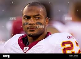 Washington Redskins running back Larry Centers (37) goes up over New  England Patriots cornerback Ty Law (24), safety Lawyer Milloy (36) and  safety Larry Whigham (25) to pick up a first down