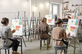 Rear View Of Female Students Of Painting Class Sitting In Front Of Easels In 2020 Painting Class Business Cards Design Diy Student