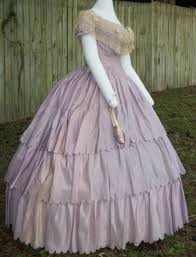 The shape of the skirt is bell shaped in the 1850s and early 1860s, transitioning from a petticoat supported skirt to a crinoline (cage or boned skirt) support. Lilac Silk Ballgown C 1860 Shown With An Original Bertha And Fan Civil War Dress War Dress Victorian Gown