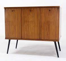 John Stuart Mid Century Modern Small Credenza With Folding Doors At 1stdibs Folding Doors Mid Century Modern Cabinets Mid Century Modern