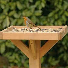 This traditional wooden bird table features a green roof and is a gorgeous addition to any garden. Rustic Wooden Bird Feeders Bird Cages
