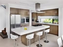 Matching the clean modern look of the kitchen space, this small movable kitchen island uses the same finishes as the main kitchen, but instead uses a solid teakwood for the counter top. Modern Small Modern Kitchen Island Designs